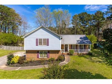 Ranch style home with brick and siding, covered porch, and landscaped yard at 553 Wellington Way, Jonesboro, GA 30238