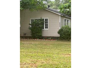 Charming home featuring vinyl siding, well-kept lawn, and mature landscaping for enhanced curb appeal at 4402 Highland Rd, Decatur, GA 30035