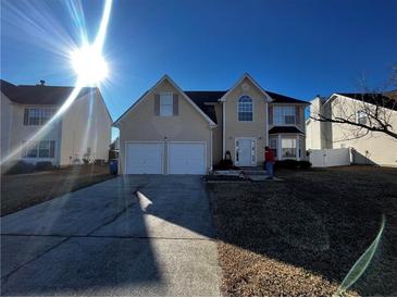 Two-story house with a two-car garage and a large front yard at 1224 Labrador Ln, Riverdale, GA 30296