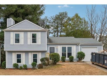 Charming two-story house with gray siding, white trim, and a well-maintained lawn at 1259 Mill Lake Cir, Stone Mountain, GA 30088