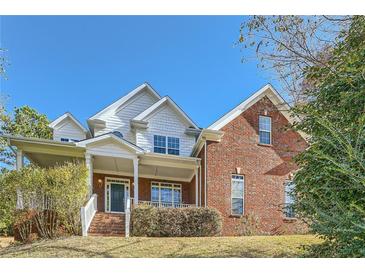 Brick two-story house with a front porch and landscaped yard at 3580 Bulloch Lake Rd, Loganville, GA 30052