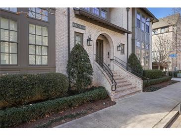 Elegant brick building exterior with manicured landscaping and a welcoming entrance at 6736 Cadence Blvd, Sandy Springs, GA 30328