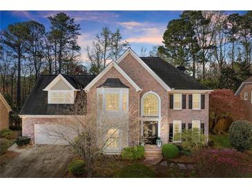 Beautiful brick home with manicured landscaping, mature trees and an attached two-car garage at 3300 Greencastle Chase Ne, Marietta, GA 30062