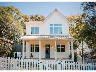 Two-story white farmhouse with a front porch and picket fence at 185 Marion # B, Atlanta, GA 30307