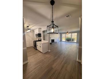 Modern kitchen features white cabinets, stainless steel appliances, and quartz countertops at 2002 Country Park Se Dr, Smyrna, GA 30080