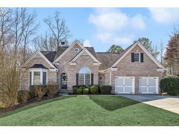 Brick house with two-car garage and landscaped lawn at 1263 Irwin Lake Way, Marietta, GA 30064