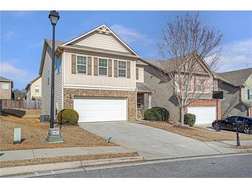 Two-story house with a white garage door and a neatly landscaped yard at 2375 Morgan Farm Dr, Buford, GA 30519