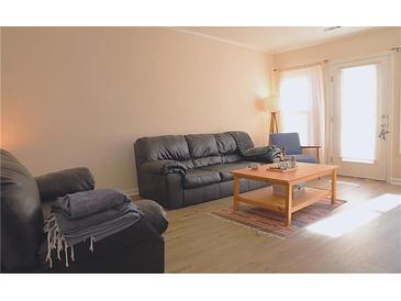 Bright living room featuring a comfy leather sofa and a coffee table at 2920 Fleetwood Dr, Cumming, GA 30041