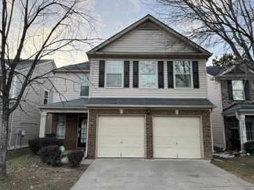 Two-story house with a double-car garage and neutral siding at 5863 Seabright Ln, Atlanta, GA 30349