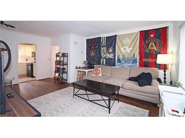 Bright living room with hardwood floors, comfy sofa, and a view of the kitchen at 692 Argonne Ne Ave # 2, Atlanta, GA 30308