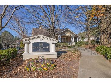 Condominium entrance with landscaping and signage for Carrington Park at Lenox at 2700 Pine Tree Ne Rd # 2306, Atlanta, GA 30324