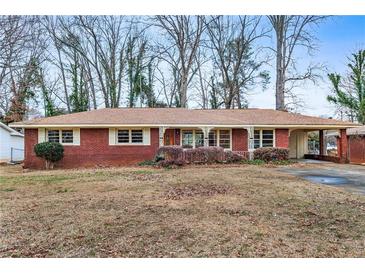 Brick ranch home with mature trees and a spacious yard at 1730 Carla Dr, Morrow, GA 30260