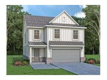 Two-story farmhouse style home with gray garage door and brick accents at 1822 Butterfly Way, Marietta, GA 30066