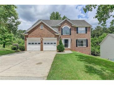 Brick house with two-car garage and well-maintained lawn at 1484 Highland Bluff Ct, Suwanee, GA 30024