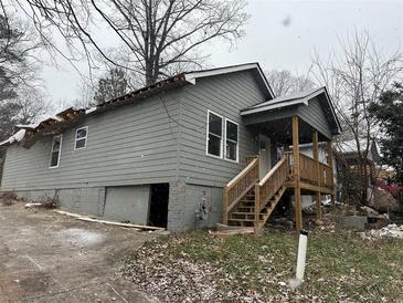 Gray house with wooden stairs and damaged roof awaiting repairs at 277 Barfield Sw Ave, Atlanta, GA 30310