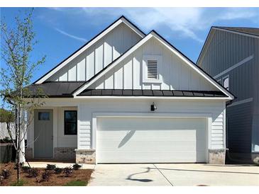 Charming single-story home with white siding, black roof, attached garage, and well-manicured lawn at 1818 Butterfly Way, Marietta, GA 30066