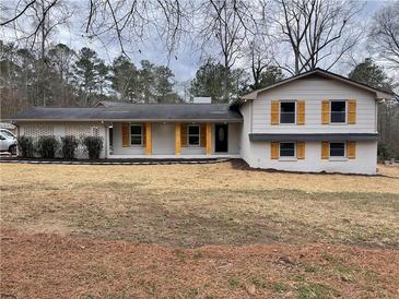 Charming home with brick accents, wooden shutters, and a well-manicured lawn at 1938 Highway 212 Sw, Conyers, GA 30094