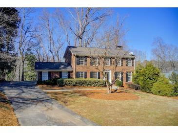 Brick house with a spacious lawn and driveway at 882 Edgewater Trl, Atlanta, GA 30328