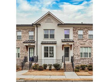 Brick front of charming townhome with steps and small landscaping at 2071 Glenview Park Cir, Duluth, GA 30097