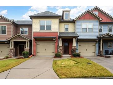 Three-unit townhome building with attached garages and landscaped lawns at 4116 Mars Bay # 27, Acworth, GA 30101