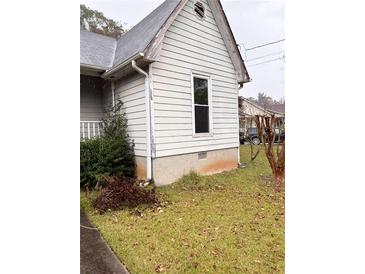 Ranch house with grey siding, visible foundation, and landscaping at 106 June Ct, Hampton, GA 30228