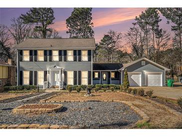 Two-story house with gray siding, shutters, and a two-car garage at 501 Fond Du Lac Dr, Stone Mountain, GA 30088