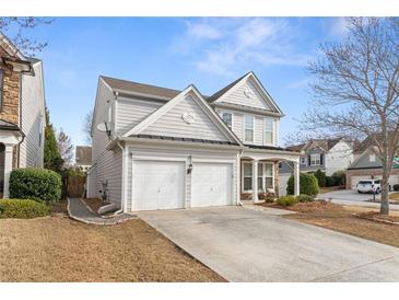 Charming two-story home featuring a two-car garage and welcoming front porch at 702 Berkeley Ter, Canton, GA 30115