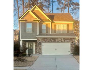 Two-story house with stone accents and a two-car garage at 102 Freedom Dr, Acworth, GA 30102