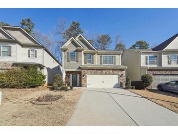 Two-story house with gray siding, stone accents, and a two-car garage at 102 Freedom Dr, Acworth, GA 30102