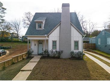 Charming craftsman style home with gray siding, a white door, and a spacious lawn at 330 Mount Zion Rd, Hapeville, GA 30354