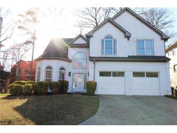 Charming two-story stucco home with a two-car garage, arched windows, and well-maintained landscaping at 4259 Creek Haven Dr, Marietta, GA 30062