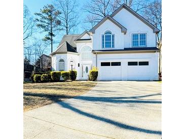 Two-story house with white exterior, landscaping, and a two-car garage at 4259 Creek Haven Dr, Marietta, GA 30062