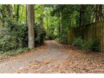 Long driveway entrance, leading to a home nestled in a wooded area at 6637 Victory Dr, Acworth, GA 30102