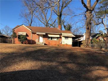 Brick ranch house with mature trees and a sloping yard at 1722 Donnalee Ave, Atlanta, GA 30016