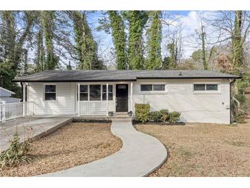 Charming single-story home featuring a black front door, white siding, and a welcoming walkway at 2529 Dale Creek Nw Dr, Atlanta, GA 30318