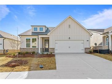 Charming single-story home featuring a two-car garage and manicured front yard at 1682 Juniper Berry Way, Loganville, GA 30052