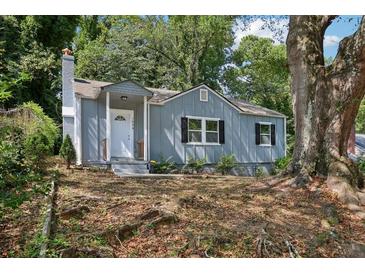 Charming single-story home featuring a light blue exterior, white trim, and a well-manicured front yard at 1626 Kenmore Sw St, Atlanta, GA 30311