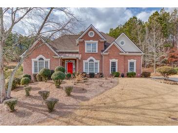 Brick house with red door, landscaped yard at 3640 Rolling Creek Dr, Buford, GA 30519