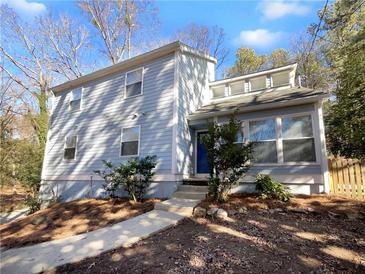 Charming two-story home with gray siding and a landscaped yard at 6049 Shallow Wood Ct, Douglasville, GA 30135