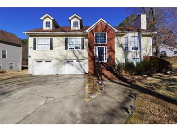 Two-story house with brick and siding, two-car garage, and landscaping at 123 Hollow Springs Dr, Hiram, GA 30141