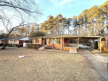 Brick ranch house with carport and spacious yard at 891 Daniell Se Dr, Smyrna, GA 30080