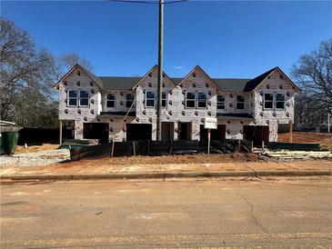 New construction triplex with gray shingle roof and vinyl siding at 11602 E Lovejoy Rd, Hampton, GA 30228