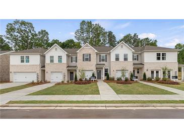 New townhome community with three-story homes and attached garages at 451 Payne Dr, Mcdonough, GA 30253