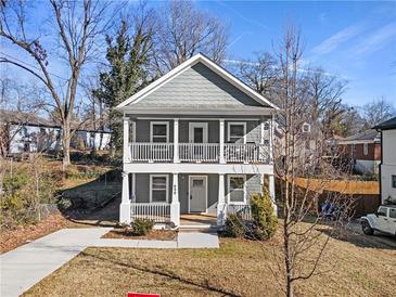 Two-story craftsman home with front porch and landscaped lawn at 698 Rochelle Sw Dr, Atlanta, GA 30310