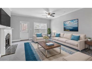 Bright living room features a fireplace, comfortable seating, ceiling fan, and stylish décor at 3044 Lauren Parc Rd, Decatur, GA 30032