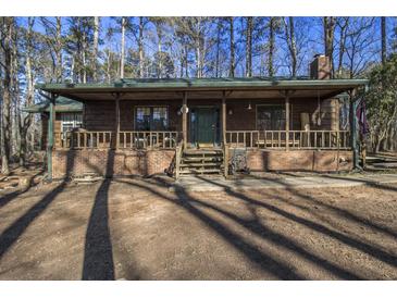 Rustic wooded home with large covered porch at 1875 Abbie Ln, Jonesboro, GA 30236