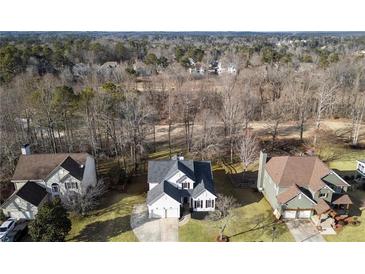 Overhead view of a two-story home featuring a well-manicured lawn and beautiful landscaping at 9776 Spyglass Dr, Villa Rica, GA 30180