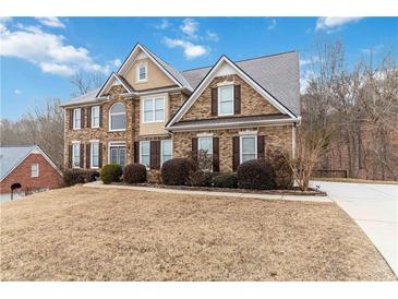 Two story brick home with landscaping and a large yard at 2155 Washington Dr, Douglasville, GA 30135