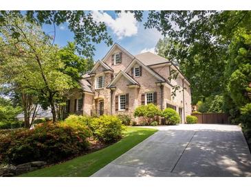 Brick two-story home with landscaped yard and driveway at 3173 Woodrow Ne Way, Brookhaven, GA 30319