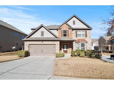 Two-story brick home with a large driveway and landscaping at 2471 Pinehurst Rdg, Atlanta, GA 30337